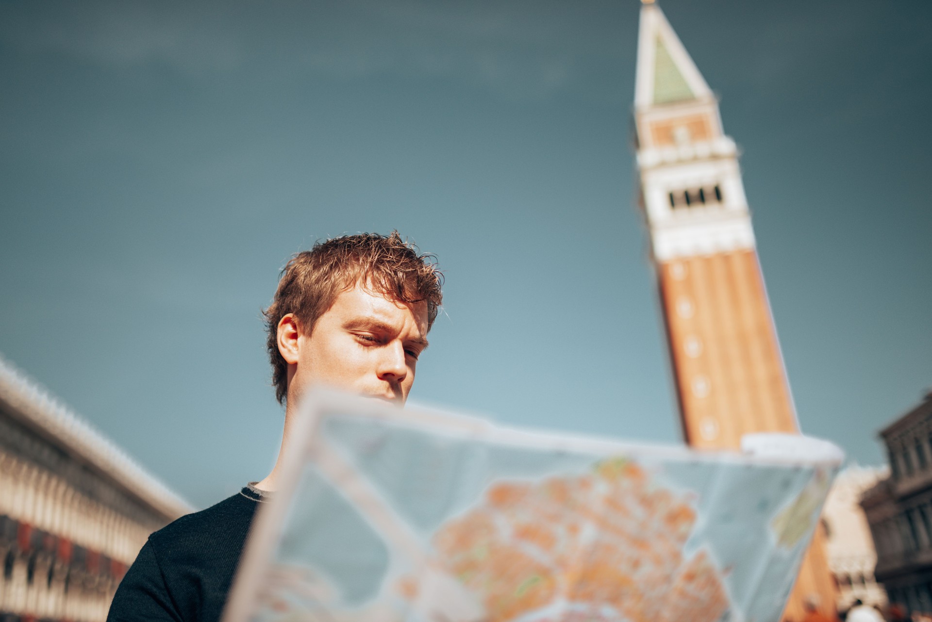 tourist in venice in st. mark square reading a map