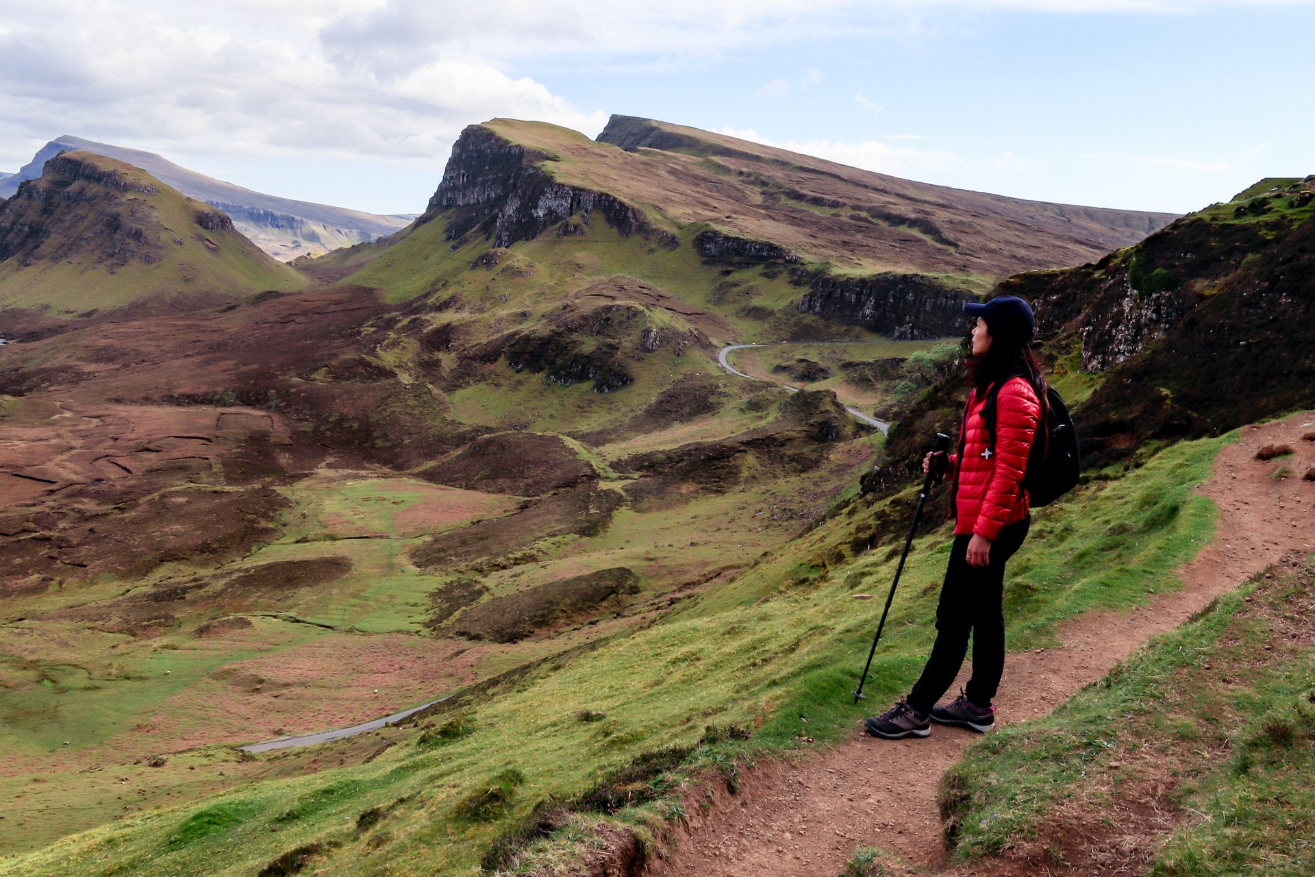 Happy woman enjoying hiking at the Quiraing, Scotland